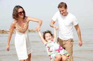 father, mother, and daughet at beach