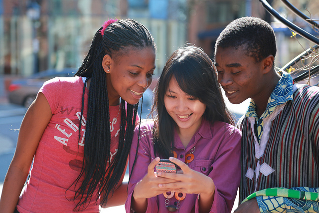 young people looking at phone
