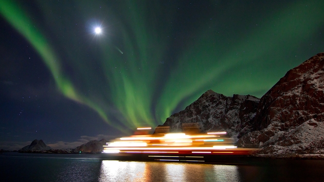 Northern light above Hurtigruten ship