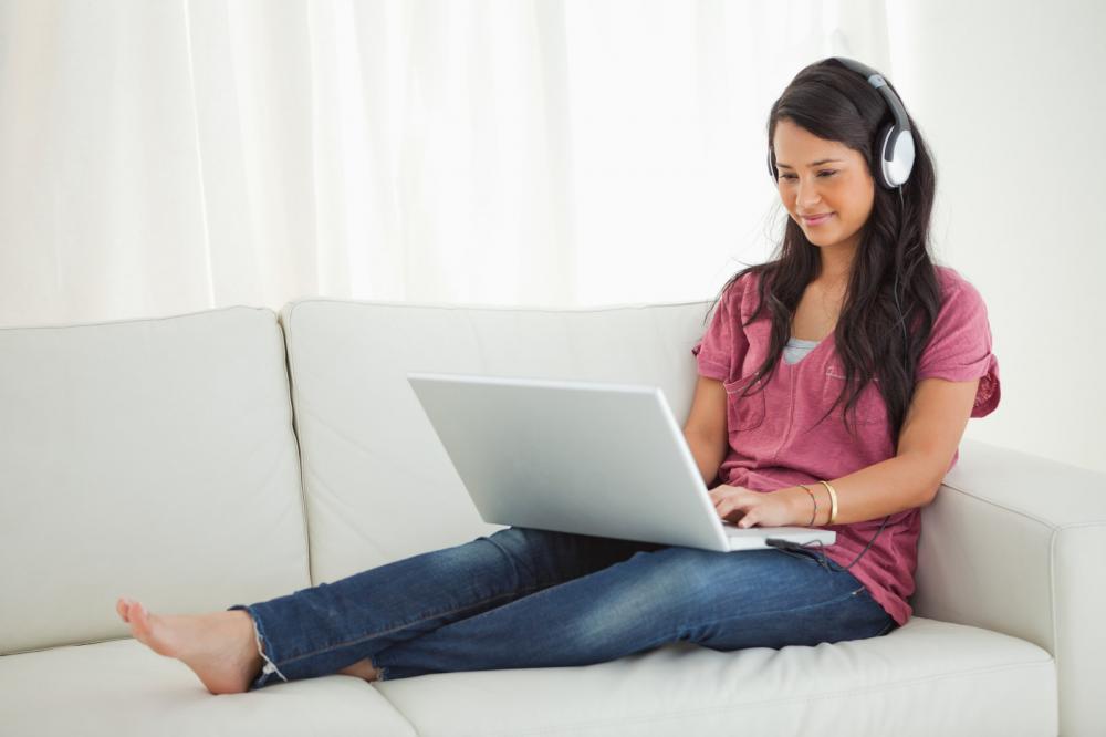 latino student with earphone language learning on laptop