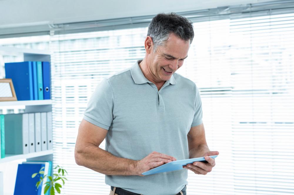 Happy man using digital tablet