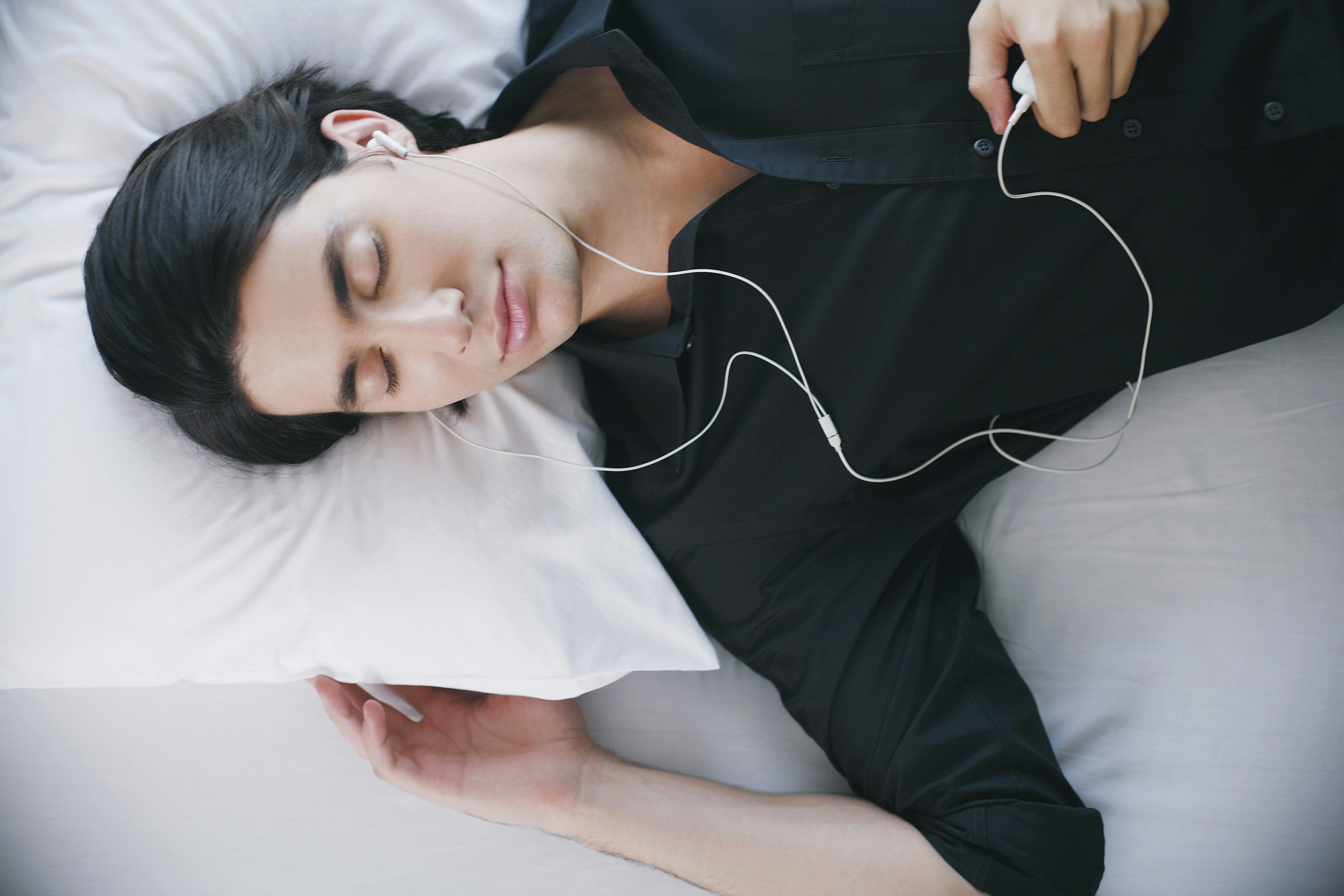 Sleeping woman with earphones- language learning?