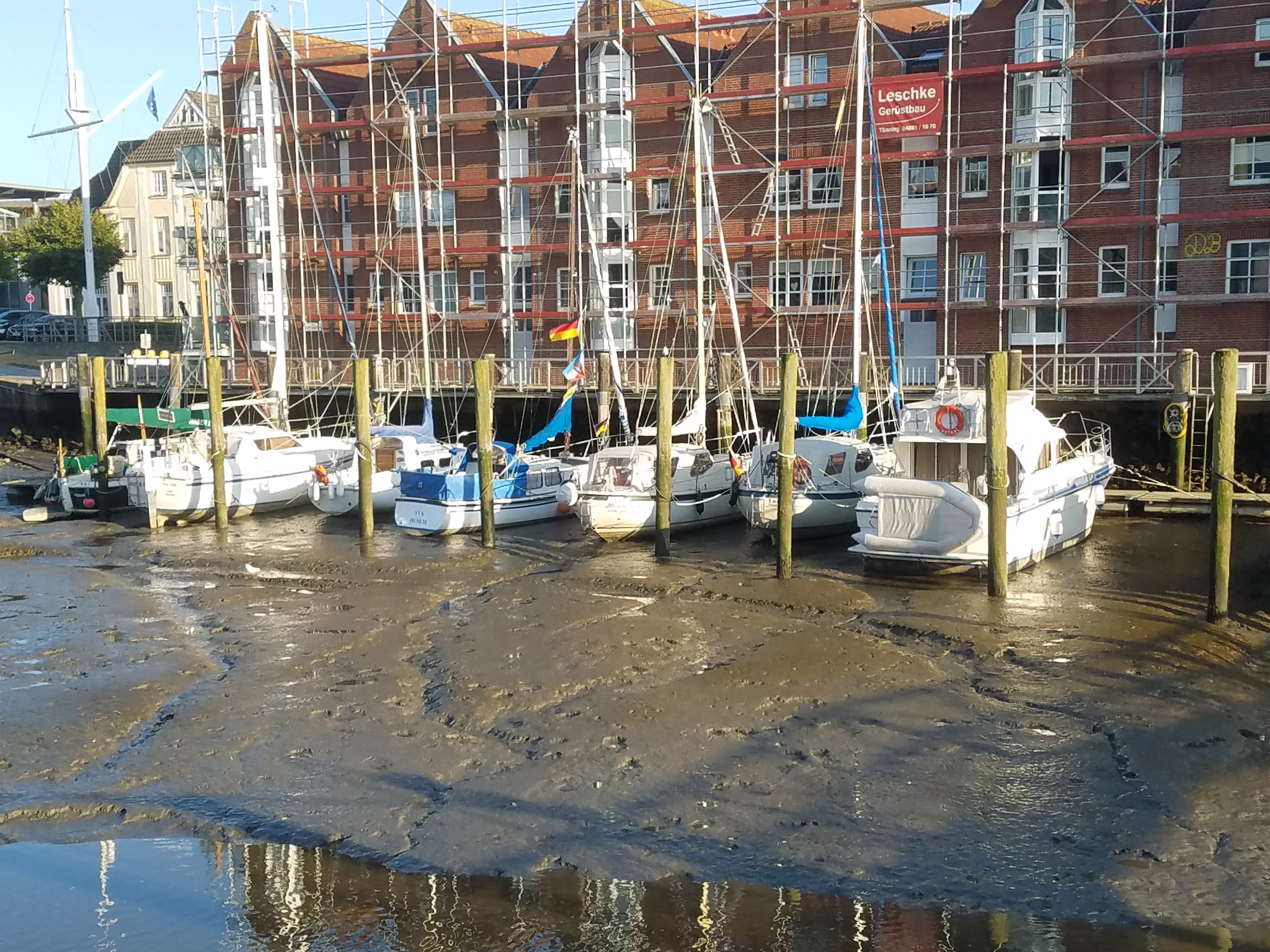 Husum Harbor at low tide with boats in mud