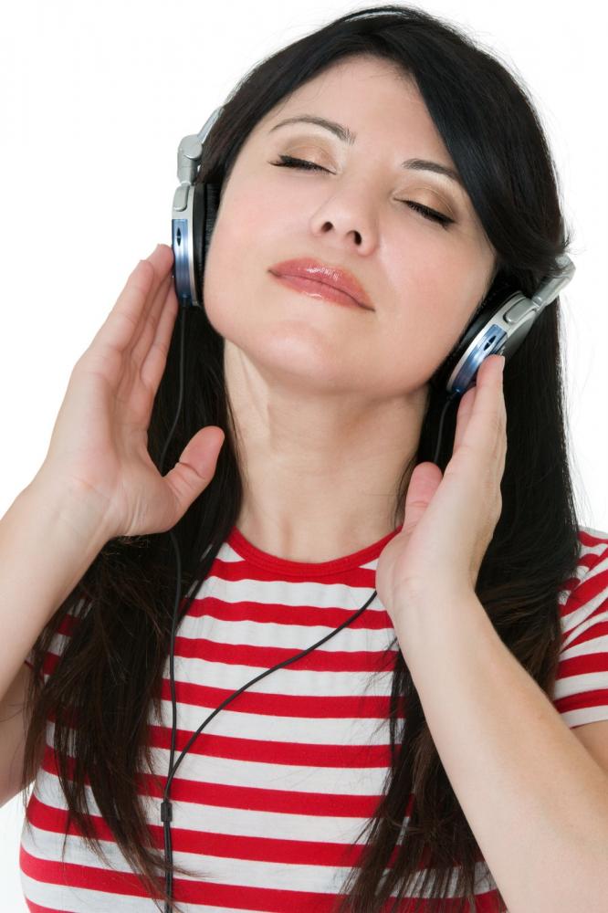 woman listing on earphones