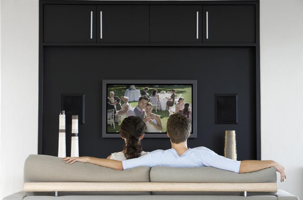 listening practice of couple-watching-movie-on-television-in-living-room