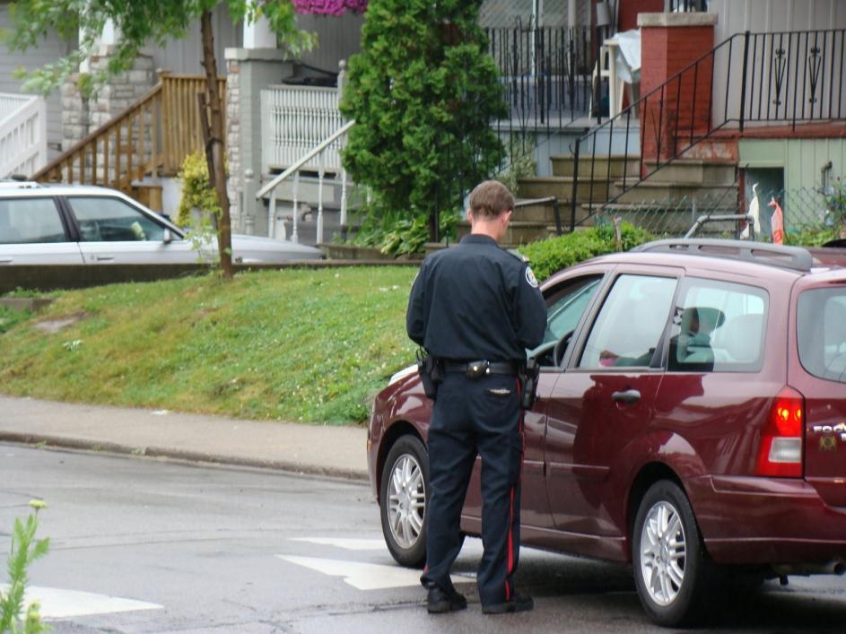 police with gun giving speeding ticket